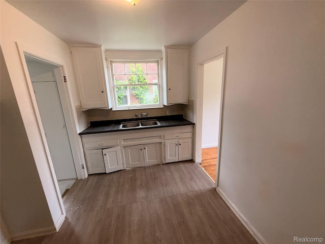 5565 Oldtown St, Detroit, MI 48224 - kitchen featuring wood finished floors, white cabinets, and dark countertops