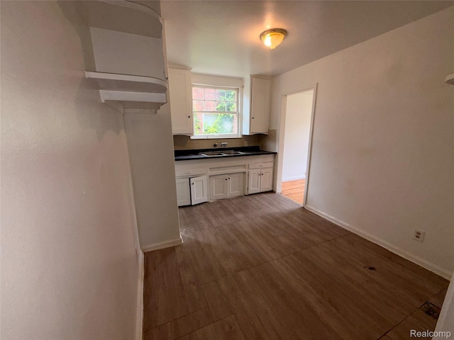 5565 Oldtown St, Detroit, MI 48224 - kitchen with dark wood-style flooring, white cabinets, and dark countertops