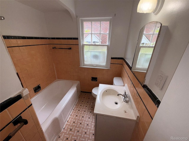 5565 Oldtown St, Detroit, MI 48224 - full bathroom with tile walls, a bathtub, vanity, wainscoting, and tile patterned flooring