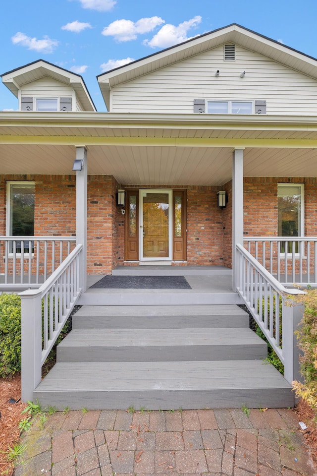 4700 Raap Rd, Bruce, MI 48065 - doorway to property featuring brick siding and covered porch