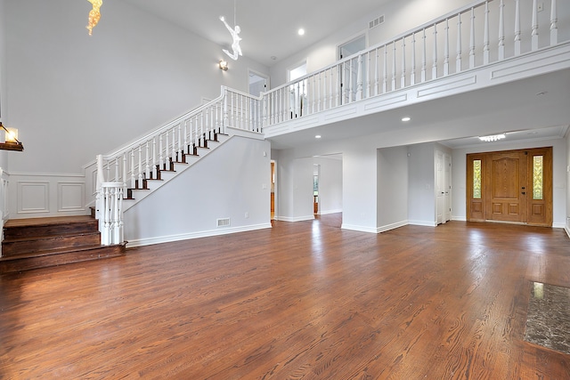 4700 Raap Rd, Bruce, MI 48065 - unfurnished living room with stairway, a towering ceiling, wood finished floors, and recessed lighting