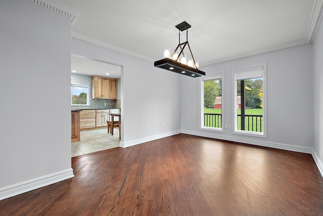 4700 Raap Rd, Bruce, MI 48065 - spare room featuring healthy amount of natural light, ornamental molding, and dark wood finished floors
