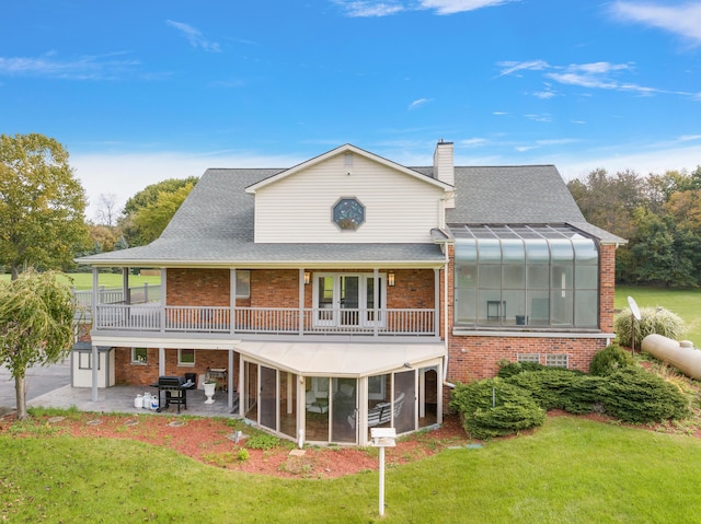 4700 Raap Rd, Bruce, MI 48065 - back of property featuring a sunroom, a patio, brick siding, and a lawn