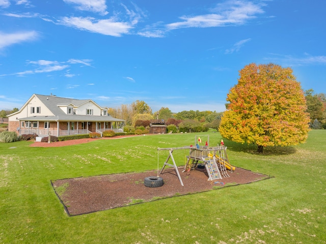 4700 Raap Rd, Bruce, MI 48065 - view of grassy yard featuring a playground and a porch