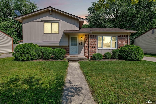 632 John Rolfe Dr, Monroe, MI 48162 - split level home with a front yard, brick siding, and board and batten siding