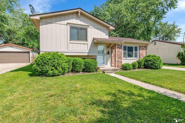632 John Rolfe Dr, Monroe, MI 48162 - tri-level home with a garage, an outbuilding, a front lawn, board and batten siding, and brick siding