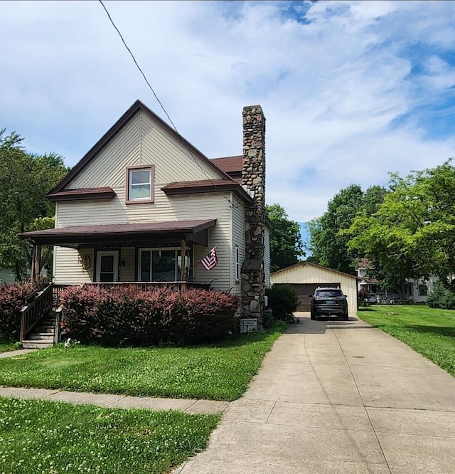 218 W Jackson, Mendon, MI 49072 - view of front of property featuring a chimney, a detached garage, covered porch, an outbuilding, and a front yard