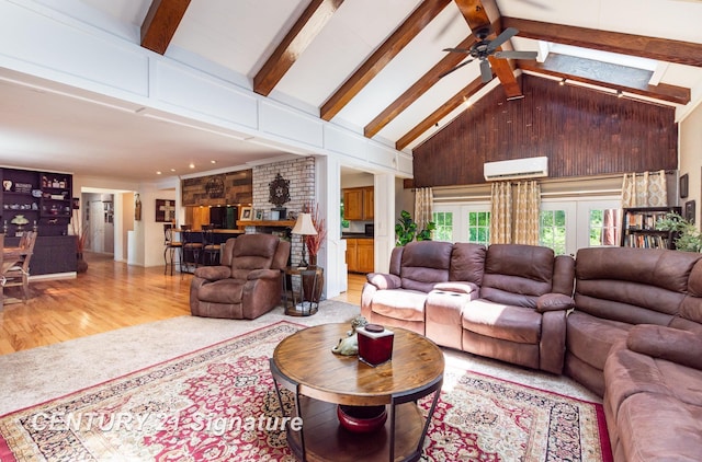 7320 N River Rd, Freeland, MI 48623 - living room with a ceiling fan, light wood-style flooring, a wall mounted air conditioner, beamed ceiling, and french doors