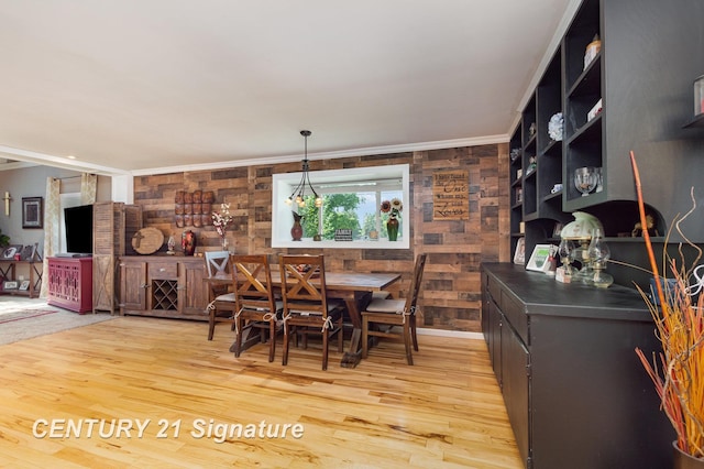 7320 N River Rd, Freeland, MI 48623 - dining room featuring light wood-style flooring, ornamental molding, and wooden walls