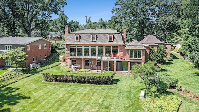 1818 Greenbriar Dr, Portage, MI 49024 - back of property featuring a chimney, brick siding, view of wooded area, a patio, and a sunroom