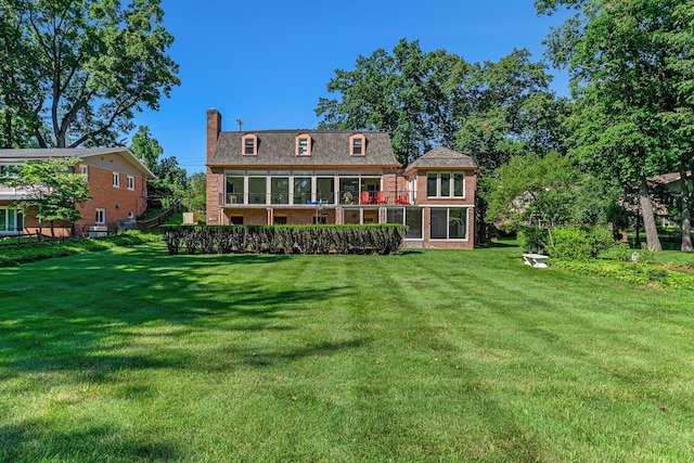 1818 Greenbriar Dr, Portage, MI 49024 - rear view of house featuring a chimney, a yard, and brick siding