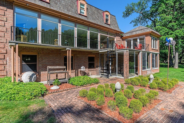 1818 Greenbriar Dr, Portage, MI 49024 - back of house featuring a balcony, brick siding, a sunroom, and a patio