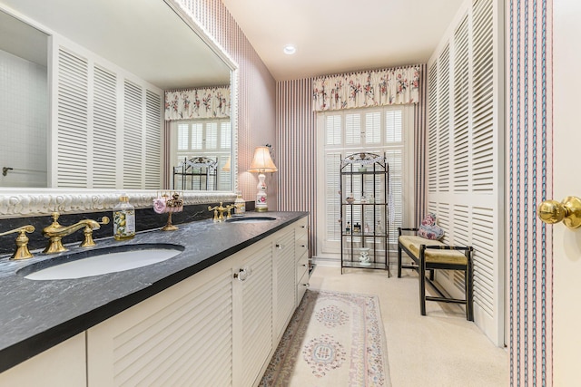 1818 Greenbriar Dr, Portage, MI 49024 - bathroom featuring double vanity, wallpapered walls, and healthy amount of natural light