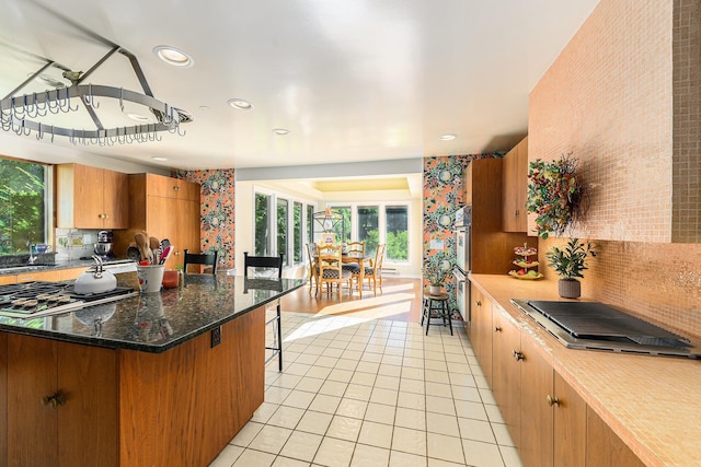 1818 Greenbriar Dr, Portage, MI 49024 - kitchen with light tile patterned floors, stainless steel gas cooktop, stainless steel cooktop, backsplash, and recessed lighting