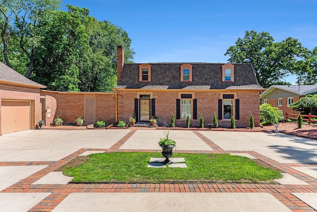 1818 Greenbriar Dr, Portage, MI 49024 - front of property with brick siding, concrete driveway, a chimney, and roof with shingles