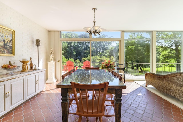 1818 Greenbriar Dr, Portage, MI 49024 - dining space with a chandelier, dark tile patterned flooring, and a wall of windows