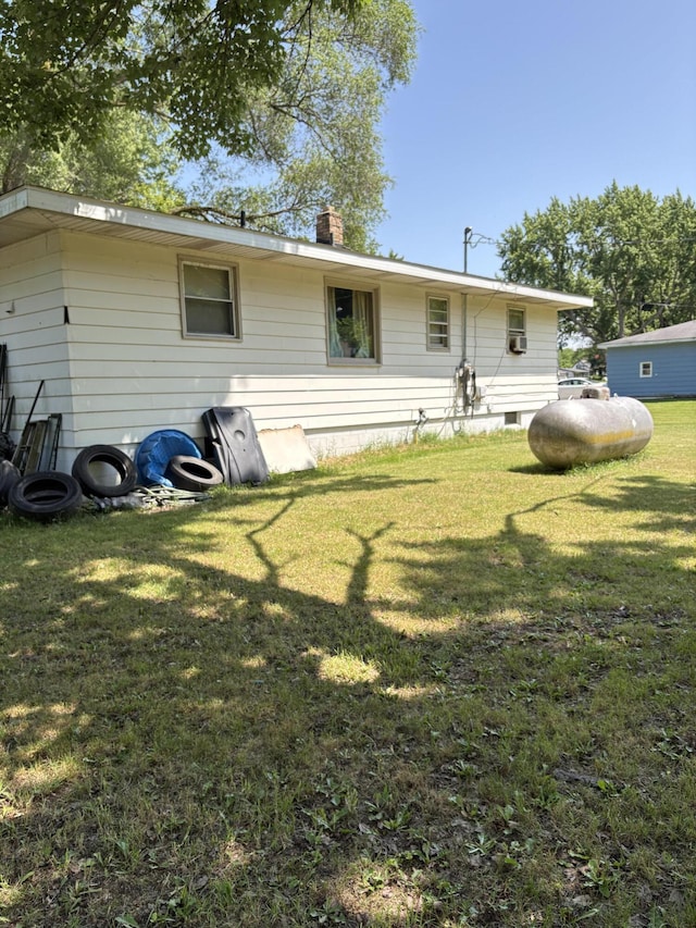 1596 Kay Dr, Benton Harbor, MI 49022 - rear view of property featuring a chimney and a lawn