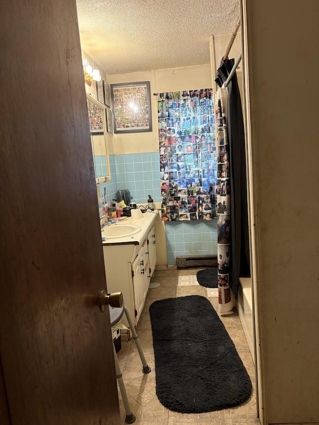 1596 Kay Dr, Benton Harbor, MI 49022 - full bathroom featuring vanity, a textured ceiling, and tile walls