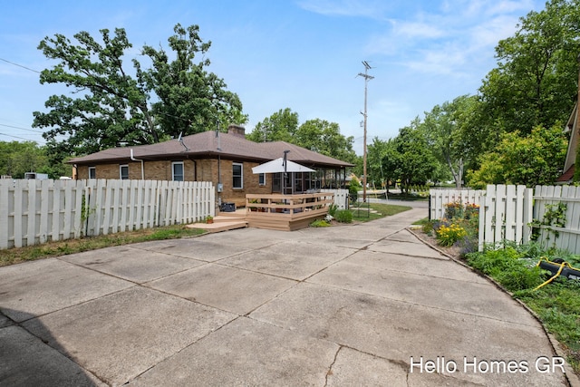 2250 Plainfield Ave NE, Grand Rapids, MI 49505 - back of property with a deck, brick siding, and a chimney