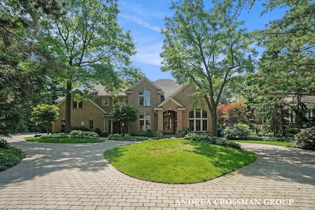 41 Bay Meadows Dr, Holland, MI 49424 - traditional-style house with curved driveway, a front yard, and brick siding