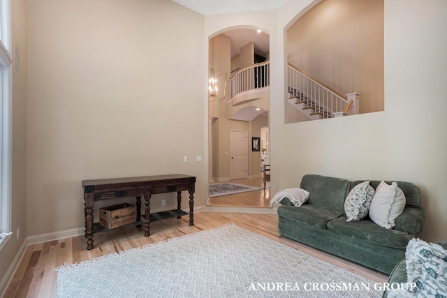 41 Bay Meadows Dr, Holland, MI 49424 - living room featuring arched walkways, wood finished floors, and a high ceiling