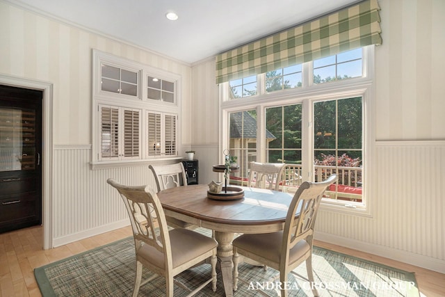 41 Bay Meadows Dr, Holland, MI 49424 - dining space featuring a wainscoted wall, light wood-style floors, wallpapered walls, and crown molding