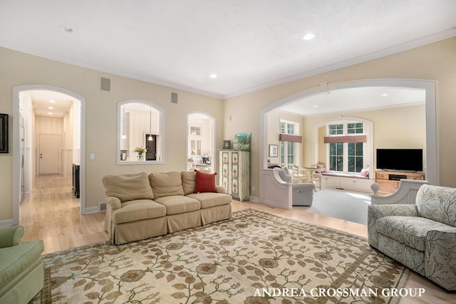 41 Bay Meadows Dr, Holland, MI 49424 - living area with arched walkways, light wood-style flooring, crown molding, and recessed lighting