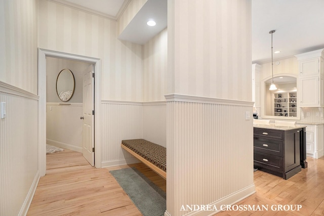 41 Bay Meadows Dr, Holland, MI 49424 - mudroom featuring wainscoting, light wood-style flooring, ornamental molding, and wallpapered walls