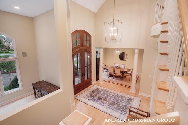 41 Bay Meadows Dr, Holland, MI 49424 - foyer entrance with french doors, wood finished floors, a chandelier, high vaulted ceiling, and recessed lighting