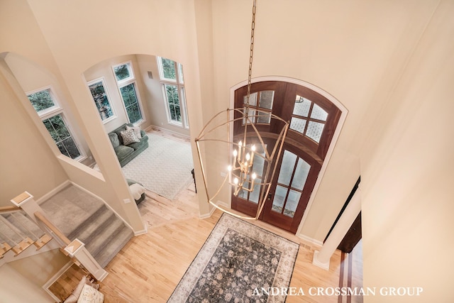 41 Bay Meadows Dr, Holland, MI 49424 - foyer entrance with arched walkways, a towering ceiling, healthy amount of natural light, and wood finished floors