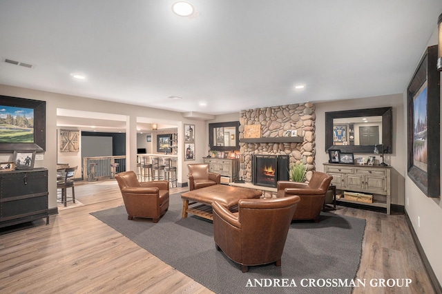41 Bay Meadows Dr, Holland, MI 49424 - living room with wood finished floors, a stone fireplace, recessed lighting, and bar area