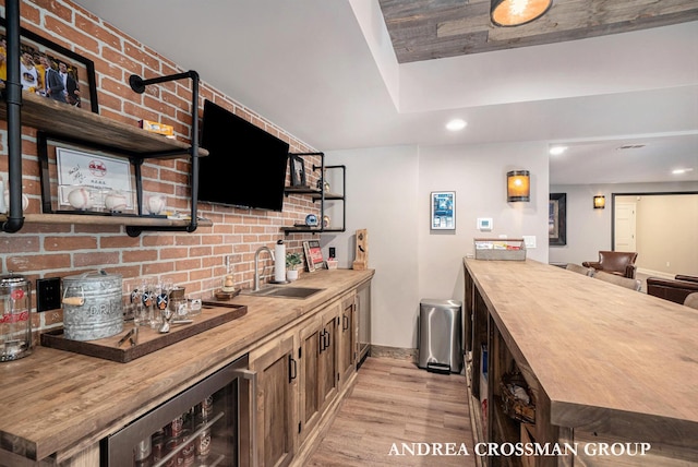 41 Bay Meadows Dr, Holland, MI 49424 - indoor wet bar featuring wine cooler, light wood finished floors, recessed lighting, and brick wall