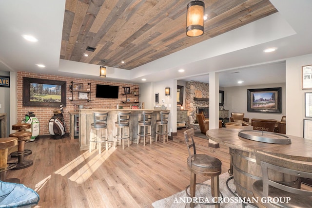 41 Bay Meadows Dr, Holland, MI 49424 - indoor bar featuring wood finished floors, a large fireplace, recessed lighting, a tray ceiling, and wooden ceiling