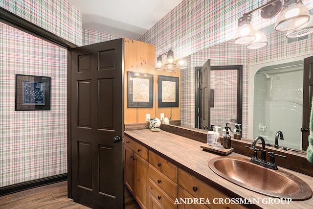 41 Bay Meadows Dr, Holland, MI 49424 - full bathroom with wallpapered walls, wood finished floors, vanity, and a chandelier