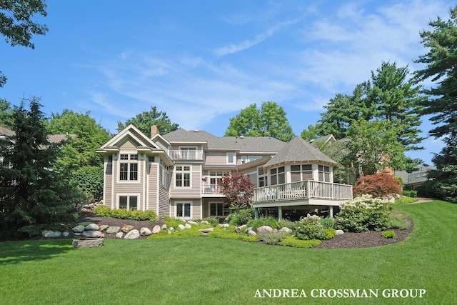 41 Bay Meadows Dr, Holland, MI 49424 - rear view of house with a sunroom, a yard, a chimney, and a wooden deck