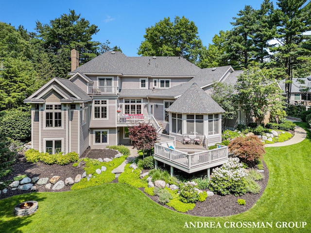 41 Bay Meadows Dr, Holland, MI 49424 - back of property featuring a sunroom, a chimney, a deck, roof with shingles, and a lawn