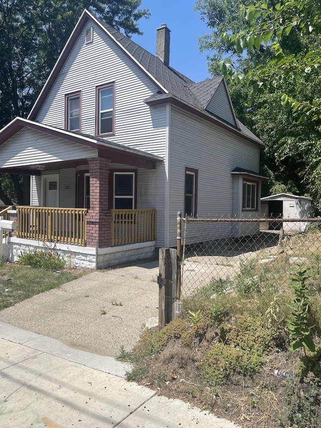 515 Hall St SE, Grand Rapids, MI 49507 - view of side of home with covered porch and a chimney