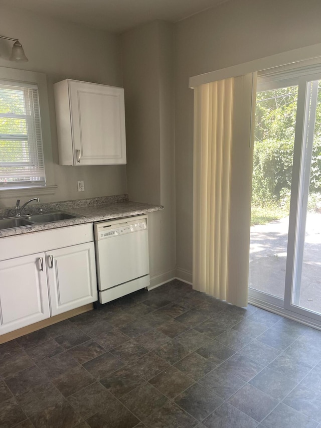 515 Hall St SE, Grand Rapids, MI 49507 - kitchen featuring white dishwasher, white cabinets, and stone finish floors