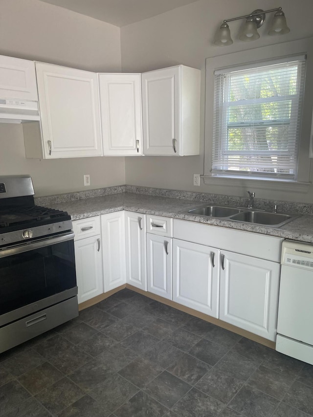 515 Hall St SE, Grand Rapids, MI 49507 - kitchen featuring stainless steel stove, white dishwasher, under cabinet range hood, white cabinetry, and stone finish flooring