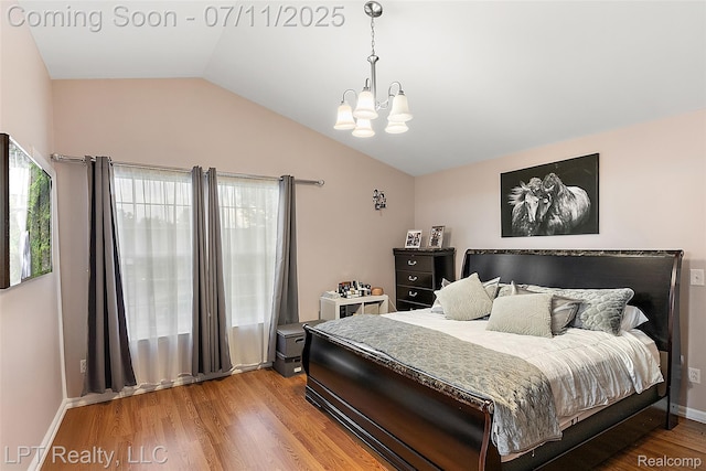17952 Marsal Dr, Macomb, MI 48042 - bedroom featuring a chandelier, vaulted ceiling, and wood finished floors