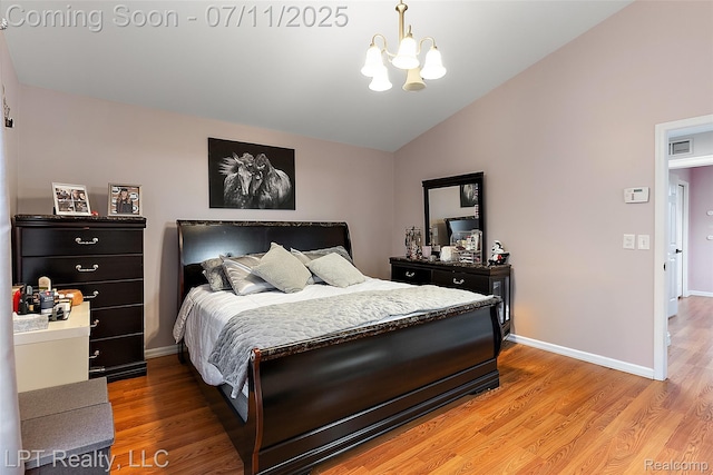 17952 Marsal Dr, Macomb, MI 48042 - bedroom featuring a chandelier, vaulted ceiling, and light wood-type flooring
