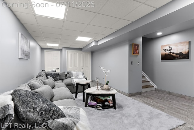 17952 Marsal Dr, Macomb, MI 48042 - living area with a paneled ceiling, wood finished floors, and stairs