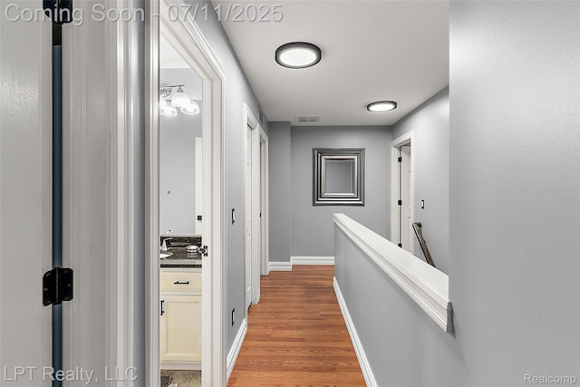 17952 Marsal Dr, Macomb, MI 48042 - hallway featuring light wood-type flooring and baseboards