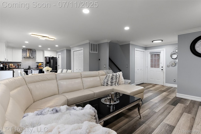 17952 Marsal Dr, Macomb, MI 48042 - living room with ornamental molding, recessed lighting, wood finished floors, and stairs