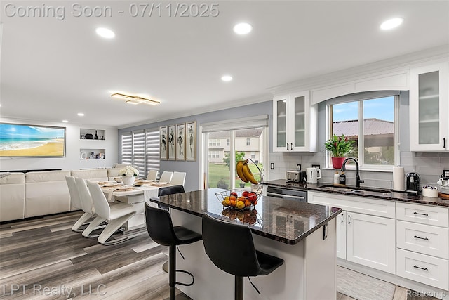 17952 Marsal Dr, Macomb, MI 48042 - kitchen featuring decorative backsplash, recessed lighting, white cabinets, a kitchen bar, and dark stone counters