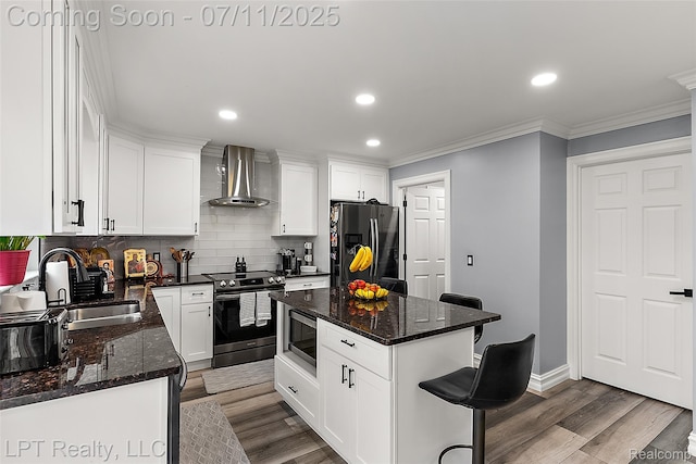 17952 Marsal Dr, Macomb, MI 48042 - kitchen featuring wall chimney exhaust hood, stainless steel appliances, ornamental molding, decorative backsplash, and wood finished floors