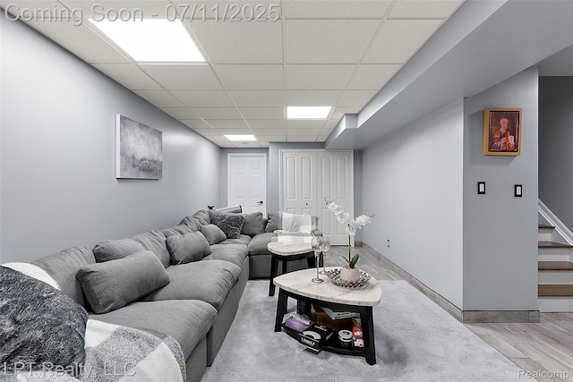 17952 Marsal Dr, Macomb, MI 48042 - living room with a drop ceiling, light wood-type flooring, and stairs