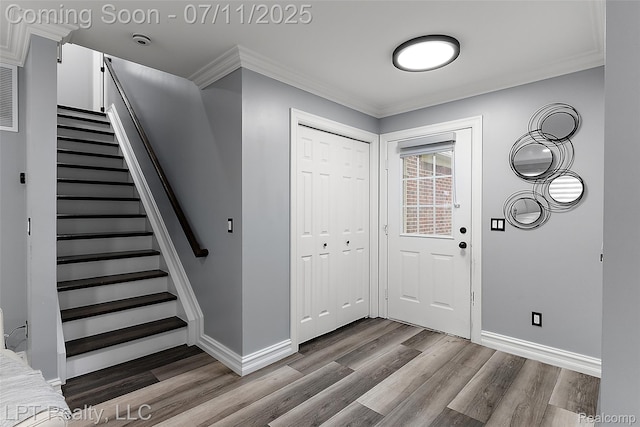 17952 Marsal Dr, Macomb, MI 48042 - entrance foyer with wood finished floors, stairs, and ornamental molding