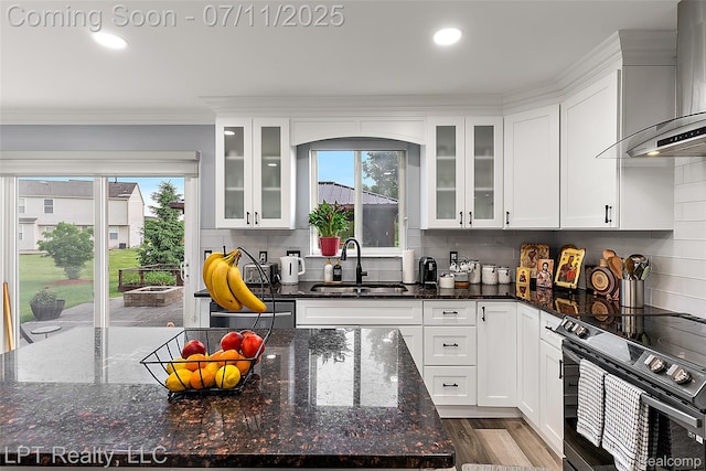 17952 Marsal Dr, Macomb, MI 48042 - kitchen featuring wall chimney range hood, electric range oven, white cabinetry, crown molding, and recessed lighting