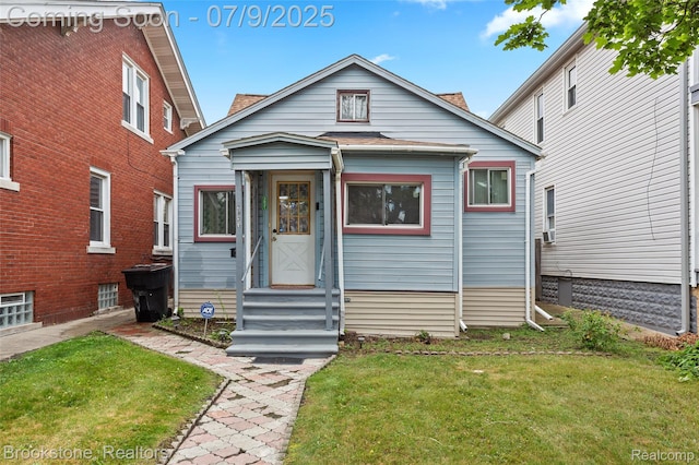 3831 Casmere St, Hamtramck, MI 48212 - view of front of home with a front yard and roof with shingles